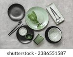 Set of stylish clean dinnerware on grey background
