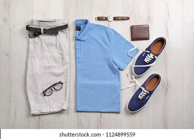 Set Of Stylish Clothes And Accessories On Wooden Floor, Flat Lay