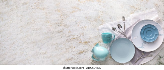 Set of stylish dinnerware on grunge background with space for text