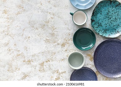 Set of stylish dinnerware on light grunge background