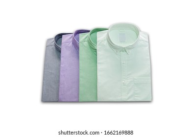 The set of stylish folded men's shirts made of cotton isolated on a white background with shadow. Business shirts isolated on a white background with shadow. Formal shirt with button down collar.