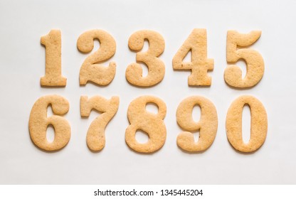 A Set Of Sugar Cookie Numerals / Gingerbread Cuted In The Form Of Numbers One, Two, Three, Four, Five, Six, Seven, Eight, Nine, Zero On A White Background.