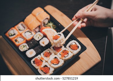 Set sushi set. Hand with chopsticks for sushi.