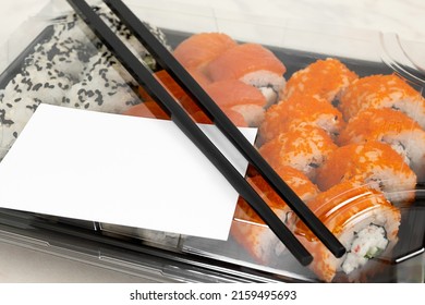 Set Of Sushi Rolls With Chopsticks And A Business Card With A Copy Space.