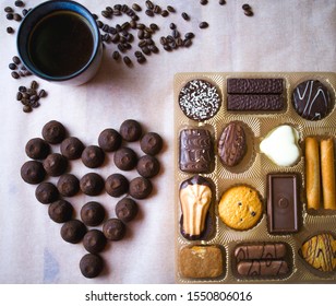 Set of sweets, cookies, coffee, chocolate truffles in a wooden box. on the table, coffee beans in the shape of a heart. a romantic gift for Valentine's day. - Powered by Shutterstock