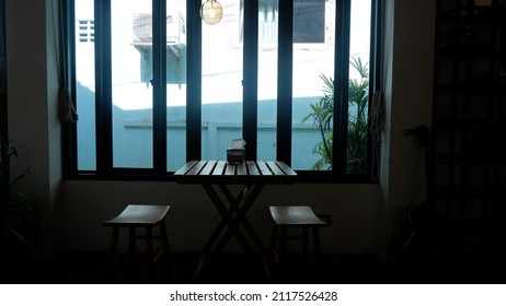 A set of table in front of windows in a coffee house