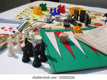 Set Of Table Games With White And Black Chess Pieces In The Foreground 