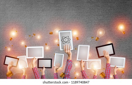 Set of tablets in female hands and glass bulbs fly around