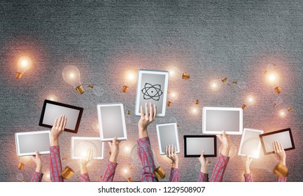 Set of tablets in female hands and glass bulbs fly around