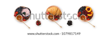 Set of three breakfast dishes, isolated on white. Top view on platters with yogurt, berries, fruits and croissants. Collage of morning meals, cutout for menu