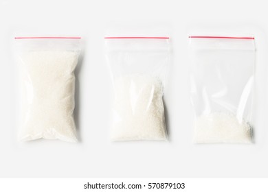 Set Of Three EMPTY, HALF AND FULL Plastic Transparent Zipper Bag With Granulated Sugar Isolated On White. Vacuum Package Mockup With Red Clip. Concept