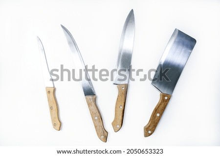 Set of three kitchen knifes and a Cleaver isolated on white background with clipping path included. Top View