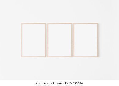 Set of three large 50x70, 20x28, a3,a4, Wooden frame mockup on white wall. Poster mockup. Clean, modern, minimal frame. Empty fra.me Indoor interior, show text or product