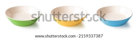 Set of three multicolored ramekins isolated on a white background. Colorful porcelain bowls cutout. Blue, yellow, green dishes. Empty crockery and tableware for food design. Front view.
