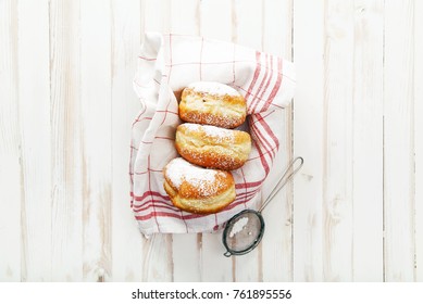 Set Of Three Sufganiyot Doughnuts With Jelly Arranged In A Box On White Wooden Background. Horizontal Composition.