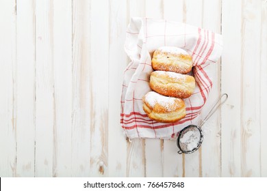 Set Of Three Sufganiyot Doughnuts With Jelly Arranged In A Box On White Wooden Background. Horizontal Composition.