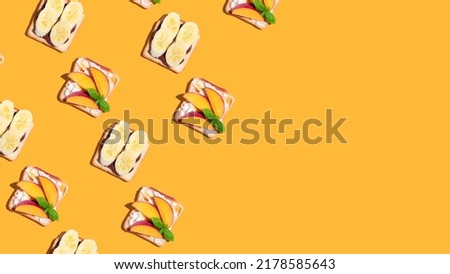 Set of toasted bread with peach and banana on yellow background. Pattern. High quality photo