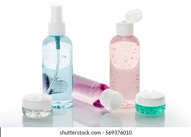 set of toiletries with water droplets on white background