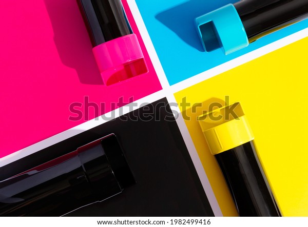 A set of toner\
cartridges for a color laser printer on the background of SMYK.\
bright creative concept\
minimal