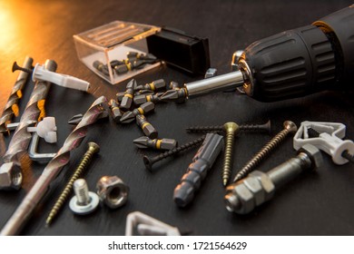 set of tools on the table, a screwdriver with a set of drill bits and screws with bolts. all for repair