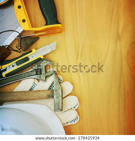 Set of tools over a wood panel with space for text