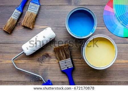 Set of tools for painting on wooden table background top view