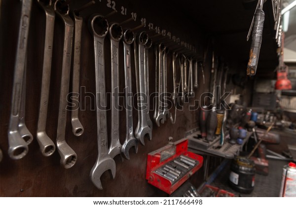 A set of tools in the real\
auto repair shop. The organization of the workplace at the\
mechanic.