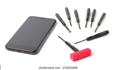 A set of tools for repairing a smartphone or tablet or cell phone. Modern smartphone, copy space. Close-up, white background, isolate.