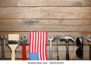Set of tools and USA flag on wooden background. Labor Day celebration - Shutterstock ID 2014131470