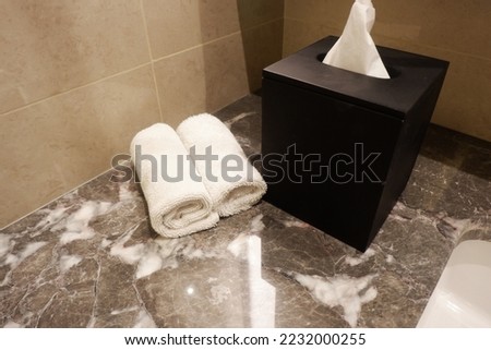 a set of towel for hand in spa salon and a cotton branch on marble table