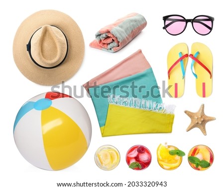 Set with towel and other beach accessories on white background