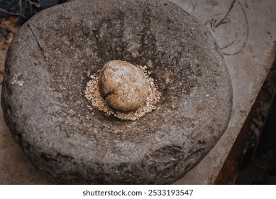 A set of traditional hard stone mortar and pestle, simple tools used to prepare ingredients or substances by crushing and grinding them into a fine paste or powder.  - Powered by Shutterstock