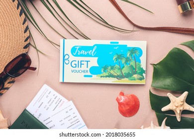 Set Of Travel Accessories And Gift Voucher On Color Background