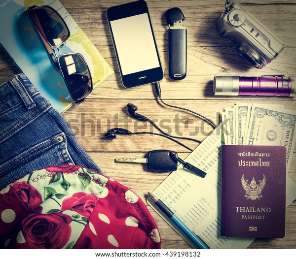 Set of travel accessory with budget on vintage\
wooden table background