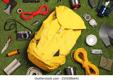 Set of traveler's equipment on green grass, flat lay - Powered by Shutterstock