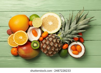 Set of tropical fruit on green wooden background, top view - Powered by Shutterstock