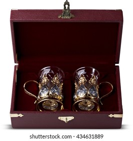 A set of two glasses with silver cup holders in finely crafted maroon, leather gift boxes
