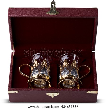 A set of two glasses with silver cup holders in finely crafted maroon, leather gift boxes