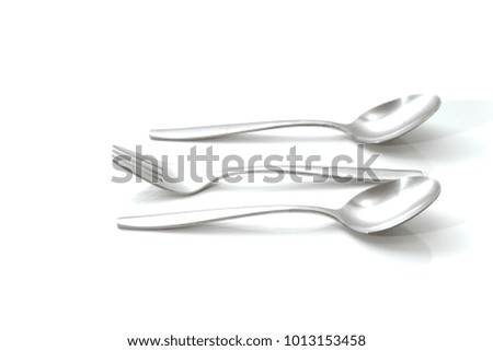 Set of two spoons and a fork on a white background