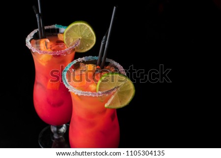 set of two summer refreshing coctails isolated on a black background. Orange alcoolic coctail or a lemonade