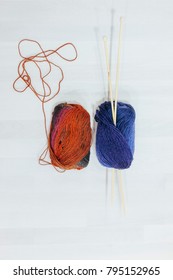 Set Of Two Wood Of Yarns With Big Knitting Needles On It