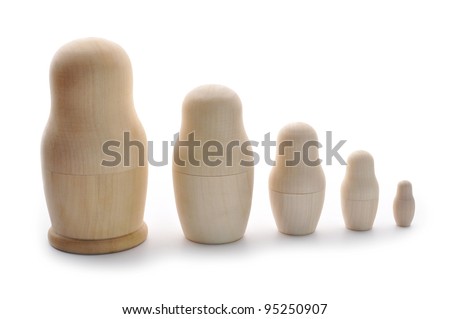 Set of unpainted nested Russian dolls on white