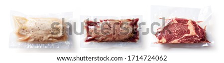 Set of  vacuum sealed meat ready for sous vide cooking. Duck breast, chicken breast and beef steak isolated on white background, top view
