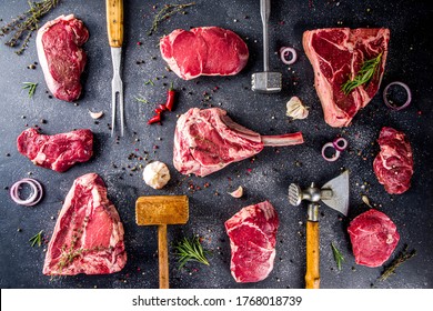 Set Of Various Butchery Meat, Different Beef Steaks With Kitchen And Grilling Utensils -  Meat Fork And Butcher Cleaver And Herbs Knife.