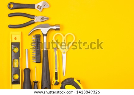 Set of various construction tools. Tools for home repair. Work at a construction site. On a yellow background. Flatly. Flatlay.