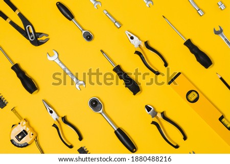 Set of various construction tools. Tools for home repair. Work at a construction site. On a yellow background. Flatly. Flatlay.