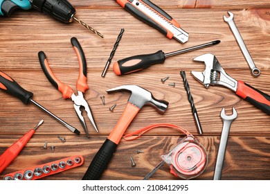 Set of various construction tools on a wooden background. Tools for home repair. Work at a construction site. Top view - Powered by Shutterstock