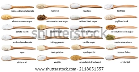 set of various cooking enhancers in wooden spoon with names isolated on white backgrouns