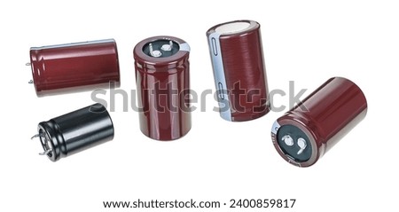 Set of various electrolytic capacitors isolated on white background. Closeup a group of passive two terminal electronic components to store energy in electrical field by accumulating electric charges.