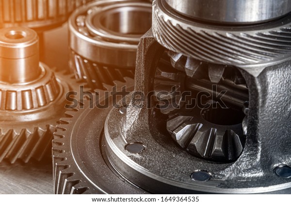 Set of various engine and gearbox spare\
parts. Shiny gears for planetary gearbox.Metal  autotechnology\
background. differential gears, close\
up